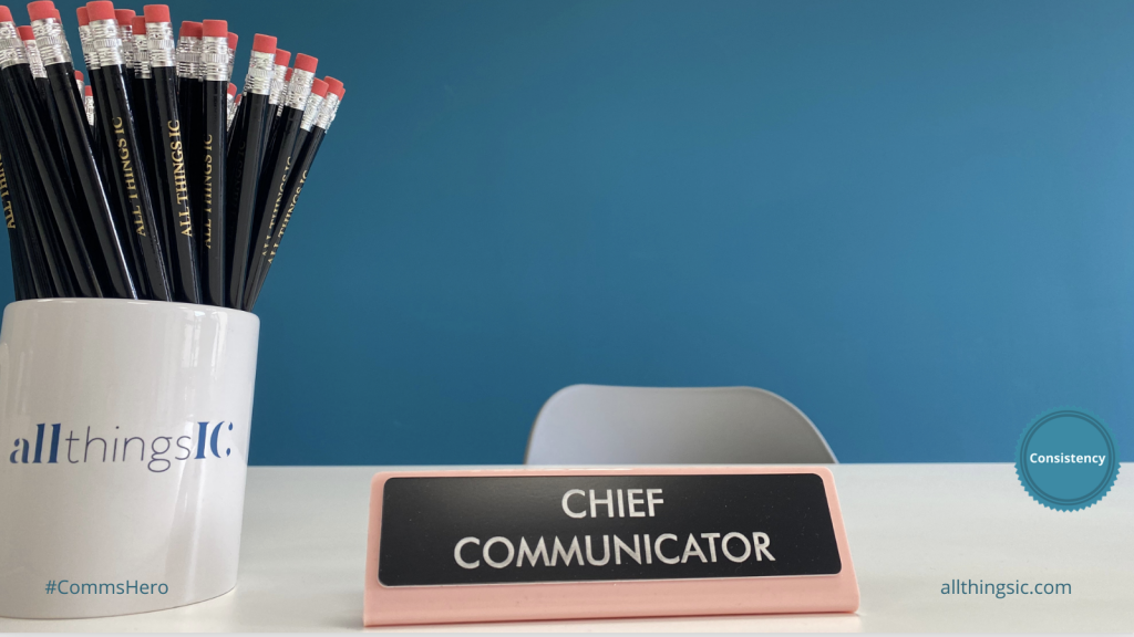 Photo shows a sign saying Chief Communicator, and a mug of All Things IC pencils.