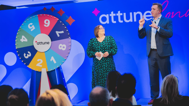 Rachel Miller and Chuck Gose stood on the Attune London stage with the Spin the Wheel